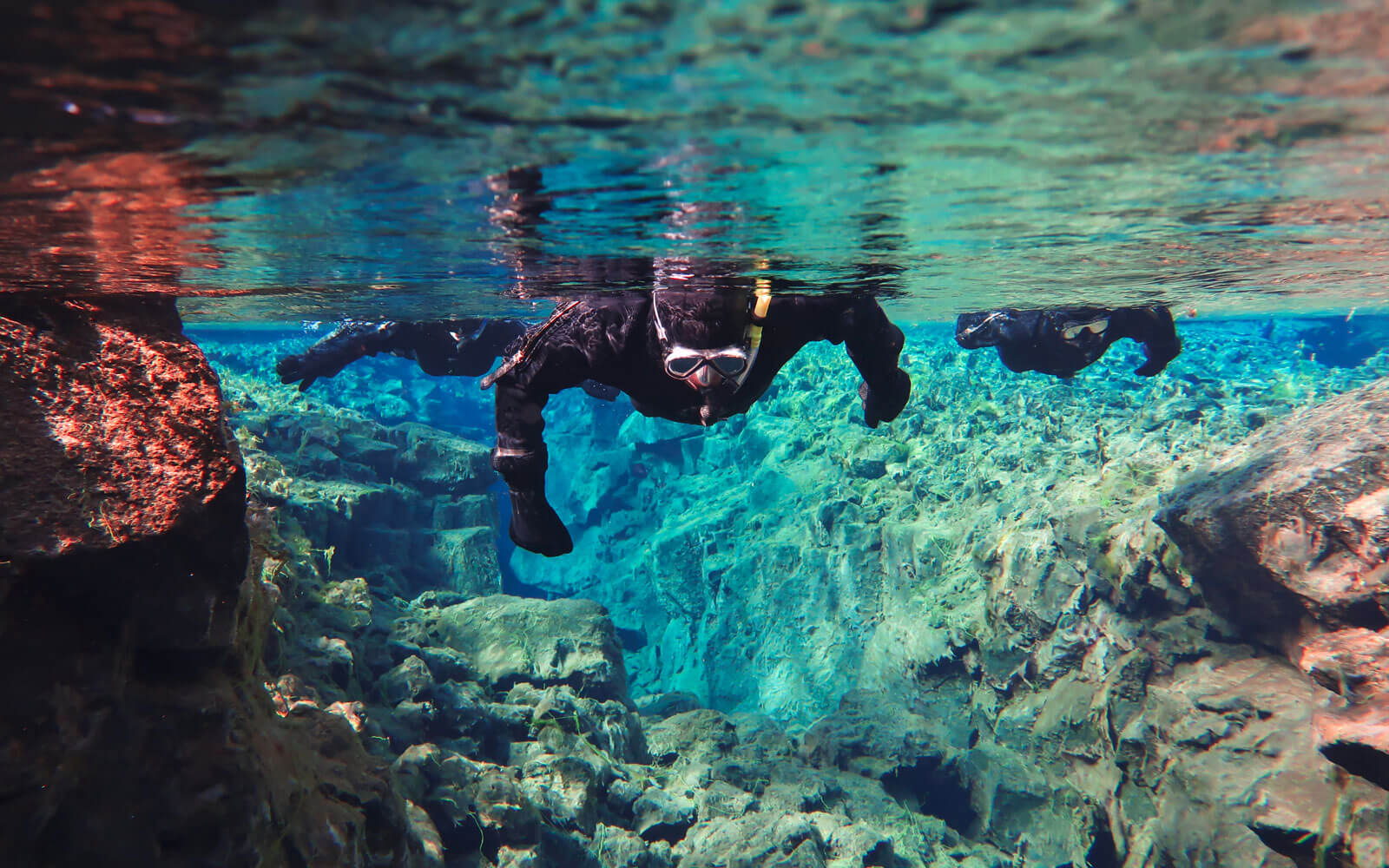 snorkeling silfra fissure during backpacker tour of iceland